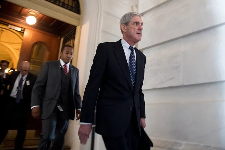 Former FBI Director Robert Mueller, front, the special counsel probing Russian interference in the 2016 U.S. election, leaves the Capitol building after meeting with the Senate Judiciary Committee on Capitol Hill on June 21, 2017 in Washington, D.C. A bill meant to protect Mueller from risk of improper termination is being reintroduced.