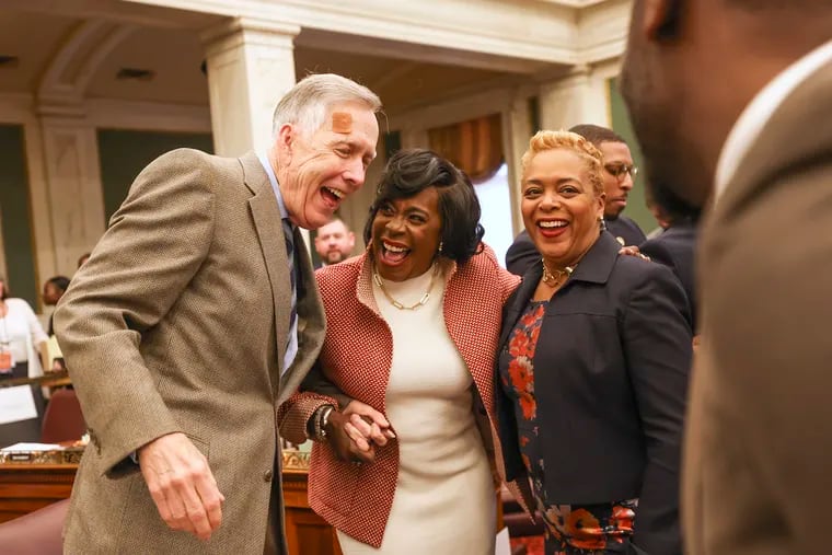 Philadelphia Mayor Cherelle L. Parker laughs and hugs city councilmembers Brian O’Neill and Cindy Bass after she delivered her first budget address in City Council chambers in Philadelphia, Pa. on Thursday, March 14, 2024.