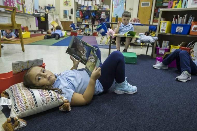 Aaliyah Vargas, left, reads in the kindergarten classroom in H.B. Hackett Elementary.