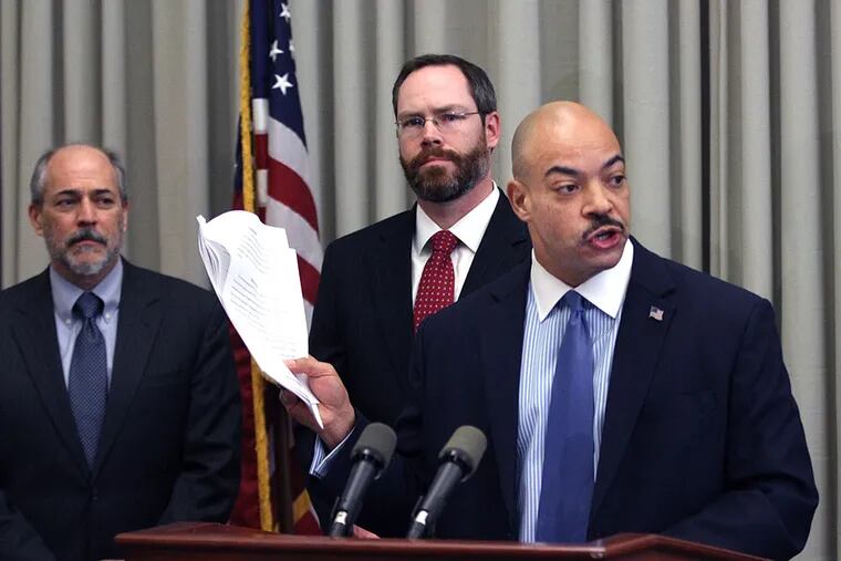 Philadelphia District Attorney Seth Williams holds up the grand jury recommendation for public-corruption charges against state Reps. Louise Williams Bishop and Michelle Brownlee and former State Rep. Harold James on Tuesday morning during his news conference. With Williams are Assistant District Attorneys Mark Gilson and Brad Bender. (MICHAEL BRYANT / Staff Photographer)