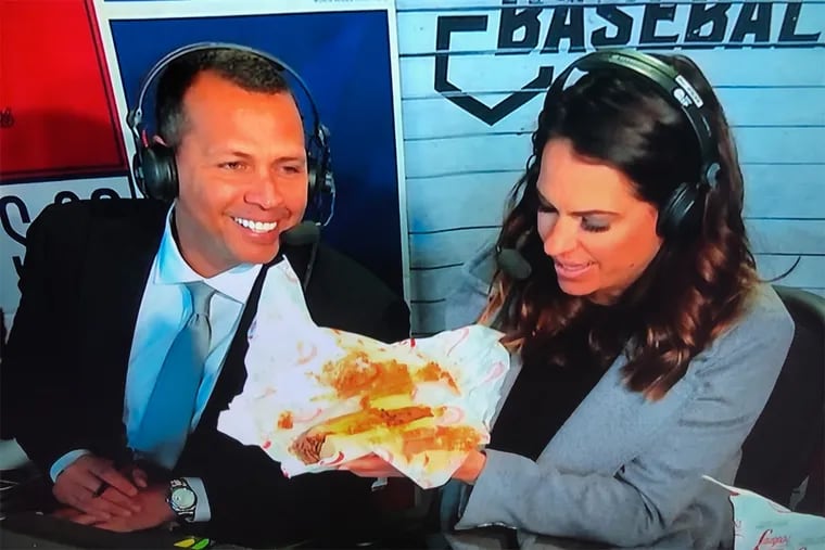 ESPN Alex Rodriguez and Jessica Mendoza  stare at a cheesesteak (or a "cheese sandwich, as A-Rod called it) during "Sunday Night Baseball" at Citizens Bank Park.