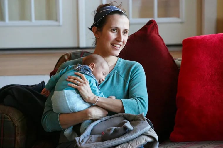 Lara Kalin holds her daughter Charlie at a breastfeeding support group meeting.
