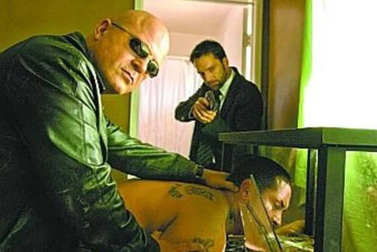 Michael Chiklis (left) portrays corrupt LAPD Detective Vic Mackey.
