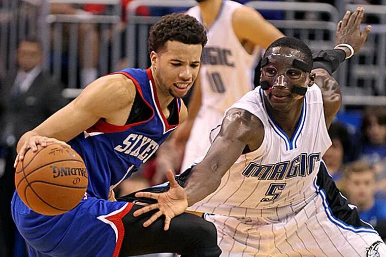Magic guard Victor Oladipo defends against 76ers guard Michael Carter-Williams. (Reinhold Matay/USA Today Sports)