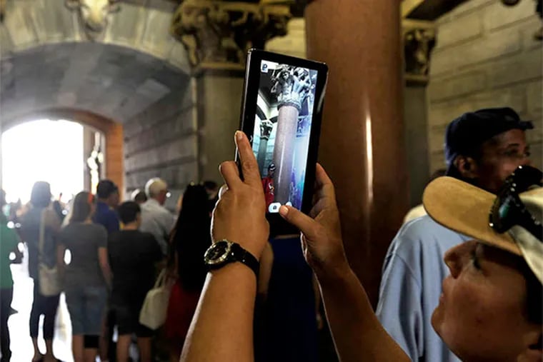 A visitor photographs inside the North Central Portal. Tours are offered daily, with some reaching the tower's top.