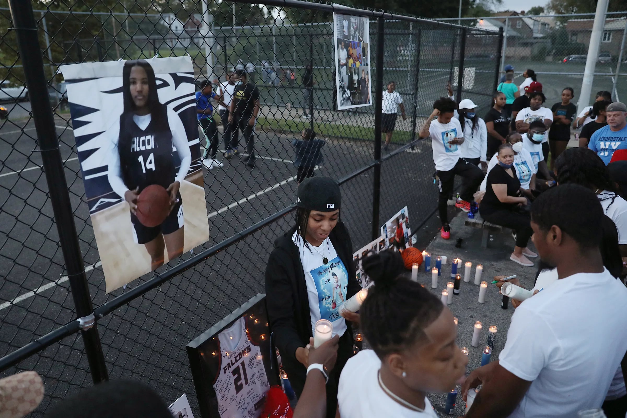 Nadira Wilson (center) placing candles after a vigil for her friend Jasmine Lewis at Sturgis Playground on Sept. 1, 2020.