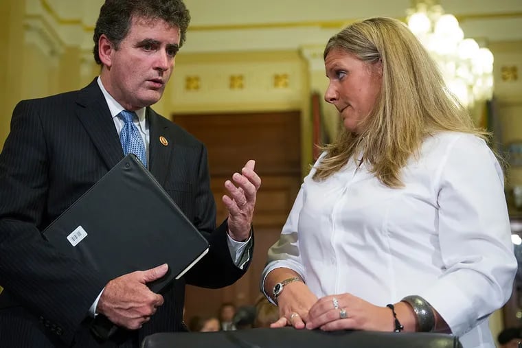 Rep. Mike Fitzpatrick, R-Pa., talks with witness Kristen Ruell, authorization quality review specialist in the Pension Management Center at the Veterans Affairs Philadelphia Regional Office, prior to her testifying to the House Committee on Veterans Affairs hearing to review the Veterans Benefits Administrations progress in achieving VA's goal of ending its disability compensation claims backlog by 2015, on Capitol Hill in Washington, Monday, July 14, 2014. (AP Photo/Cliff Owen)