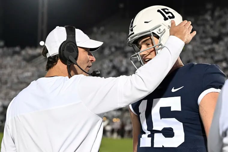 Penn State offensive coordinator Mike Yurcich talks with quarterback Drew Allar (15). Yurcich and Allar put forth a commanding win over Iowa last week. Next up is Northwestern.