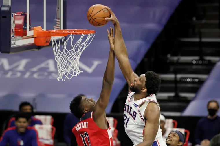 Sixers Joel Embiid dunking over the Wizards' Thomas Bryant on Jan. 6.