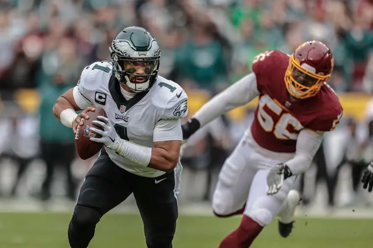 Philadelphia Eagles quarterback Jalen Hurts (1) looks to pass in front of Washington Football Team defensive end Will Bradley-King (56) during the 2nd quarter at FedEx Field in North Englewood, MD, Sunday, January 2, 2022.