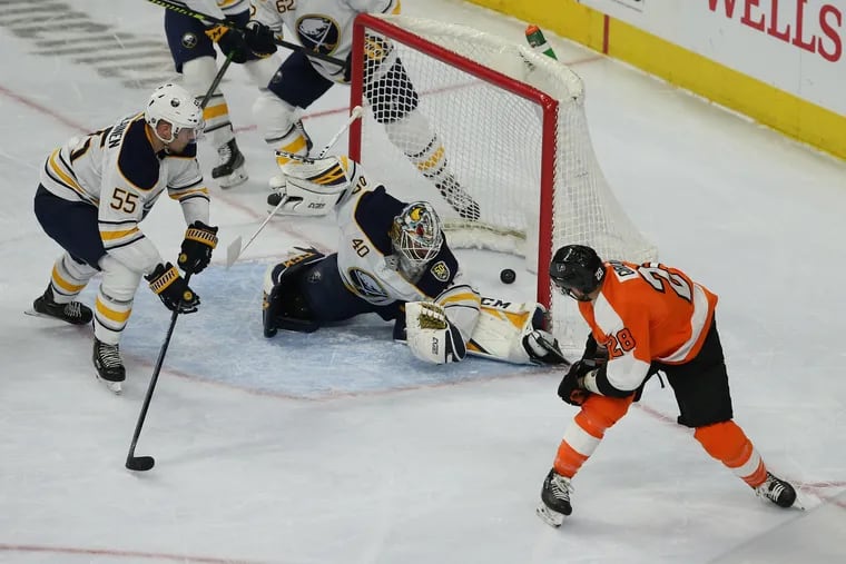 Flyers captain Claude Giroux (right) scoring against Buffalo's Carter Hutton on March 7. Giroux skated in Ottawa on Thursday.