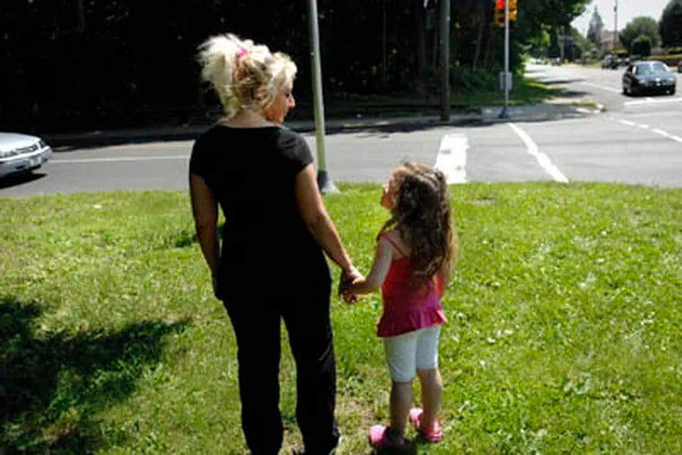 Theresa Sautter and her daughter, Skylar, 6, stand by the intersection of Rhawn Street and Lexington Ave. where Theresa's daughter, Marylee Otto was killed.   (Alyssa Cwanger / Staff Photographer)