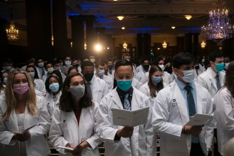 Students at Thomas Jefferson University's Kimmel Medical College read the Hippocratic oath at a 2021 ceremony where they received their white coats.