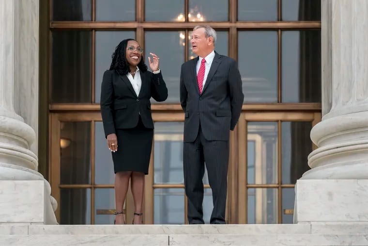 Justice Ketanji Brown Jackson (left) is escorted by Chief Justice of the United States John Roberts after her formal investiture ceremony at the Supreme Court in Washington.
