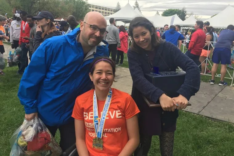 Emelia Perry (center) is flanked by her friend, Keith Rodemer and sister Mariko Perry after Sunday’s Broad Street Run. The former runner, competed in the Broad Street Run twice before returning  to compete in the wheelchair division.