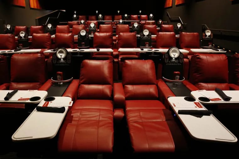 Reclining theater seats with pivoting dining trays are among the amenities in AMC's Dine-In Theatre at Block 37 in downtown Chicago. AMC says theaters with recliners have seen a 40 to 60 percent rise in attendance.