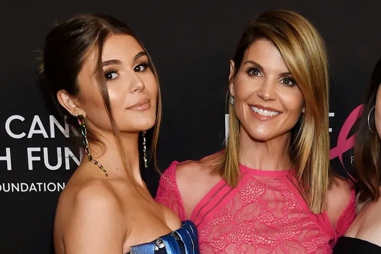 Actress Lori Loughlin (right) with her daughter Olivia Jade Giannulli in February 2019. Loughlin  was among those charged in March with fraud and conspiracy in a scheme that according to federal prosecutors saw wealthy parents pay bribes to get their children into some of the nation’s top colleges. (Chris Pizzello/Invision/AP, File)