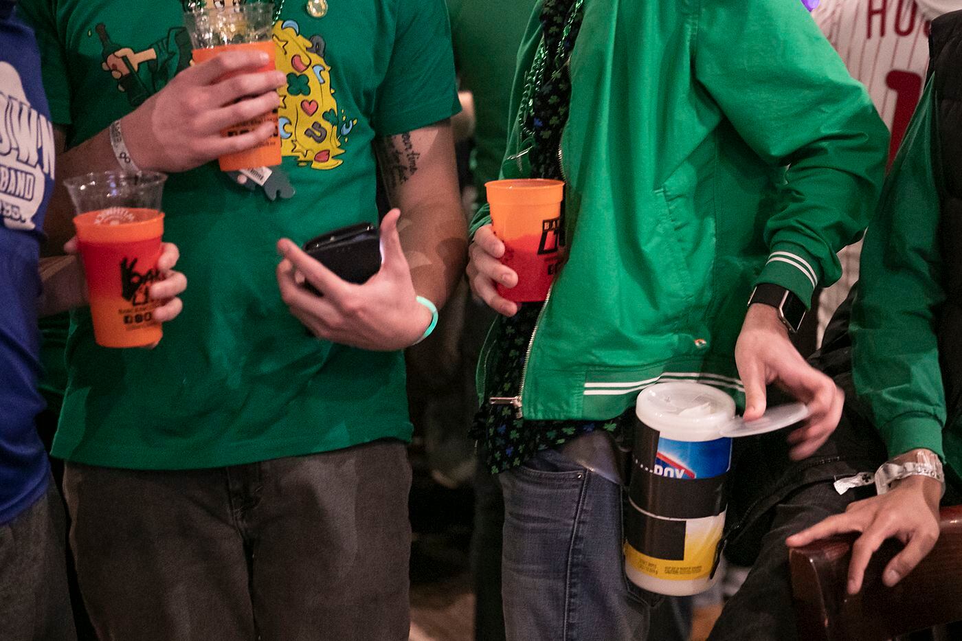 Jake Shea, 21, a student at the University of the Sciences in Philadelphia, tapes a Clorox container around his waist while celebrating St. Patrick's Day at the Field House bar in Center City Philadelphia on Saturday.