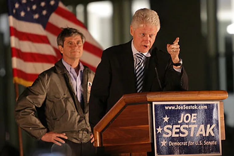 Former President Bill Clinton talks to Temple University students Thursday night as Democratic candidate for Senate Joe Sestak listens. (Yong Kim / Staff Photographer)