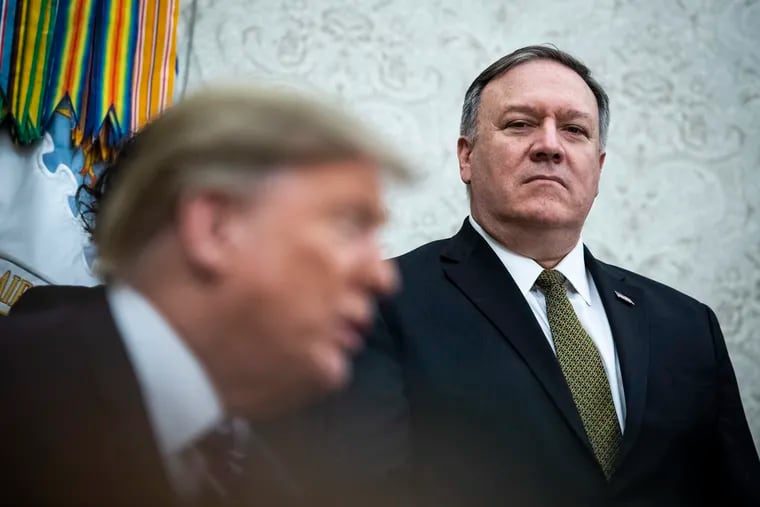 Secretary of State Mike Pompeo listens as President Donald Trump talks during a meeting in the Oval Office on Feb. 20, 2019. Pompeo on Sunday seemingly contradicted President Donald Trump on whether North Korea poses a nuclear menace — and then swiftly denied that there was any divergence in their views.