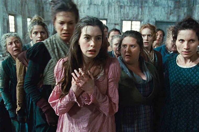 Anne Hathaway (center) stars as Fantine in "Les Miserables."