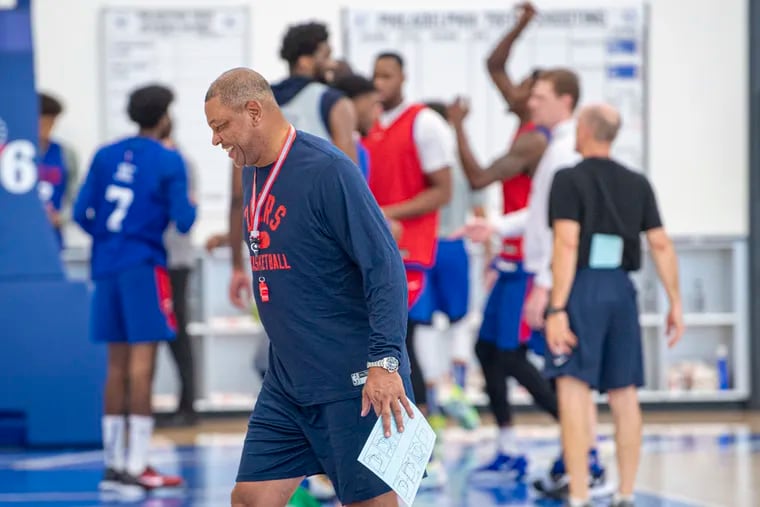 Sixers coach Doc Rivers walks along the court, during practice at the Seventy Sixers Practice Facility in Camden, N.J.