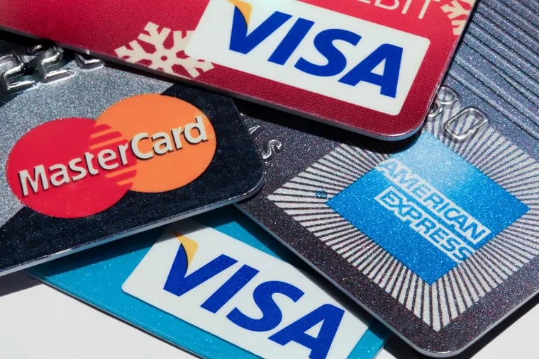 Americans are defaulting on their credit cards at the highest rate in nearly a year. Experts blame the improving economy.