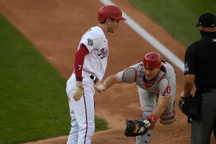 Phillies catcher J.T. Realmuto tags Washington's' Trea Turner out in the third inning of the first game on Tuesday.