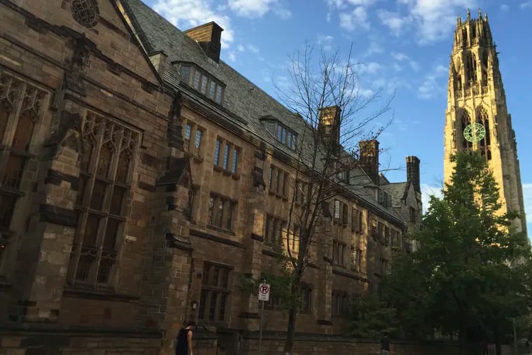 FILE - This Sept. 9, 2016 photo shows Harkness Tower on the campus of Yale University in New Haven, Conn. Dozens of people were charged Tuesday, March 12, 2019, in a scheme in which wealthy parents allegedly bribed college coaches and other insiders to get their children into some of the nation's most elite schools. (AP Photo/Beth J. Harpaz, File)