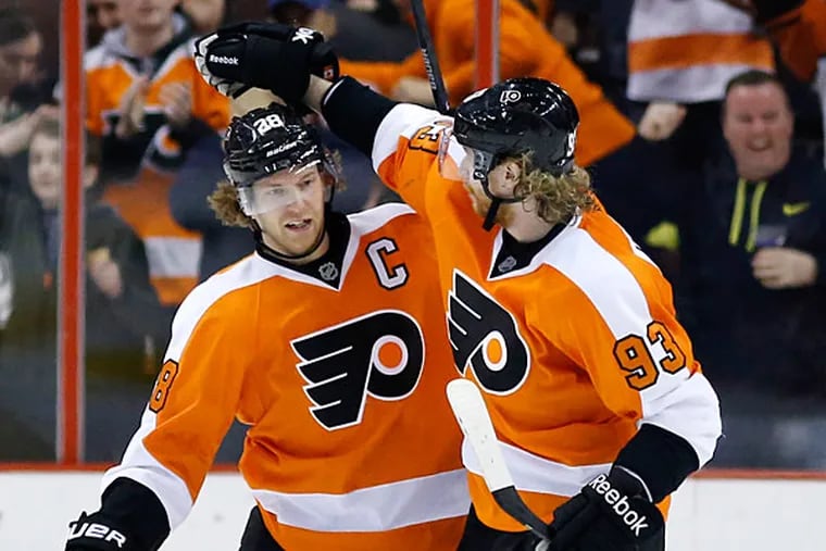 Claude Giroux (28) and Jakub Voracek (93), of the Czech Republic, celebrate after Giroux's goal during the third period of an NHL hockey game against the Toronto Maple Leafs, Friday, March 28, 2014, in Philadelphia. Philadelphia won 4-2. (Matt Slocum/AP)