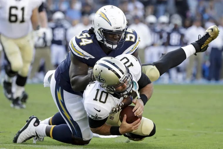 Melvin Ingram (top), sacking New Orleans quarterback Chase Daniel in the preseason, and Joey Bosa form quite a pass-rush duo.