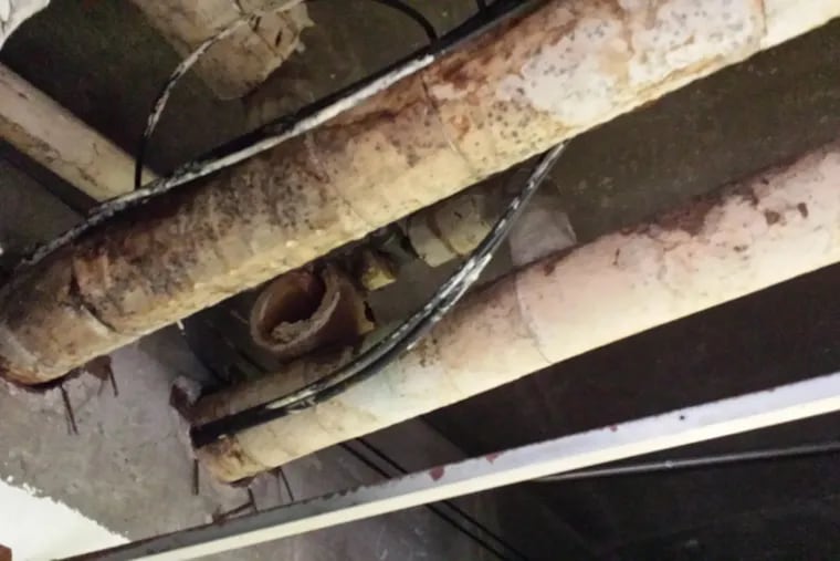 Overhead pipes at John B. Kelly Elementary School in 2015 display the building’s longstanding problem with mold, teachers say.