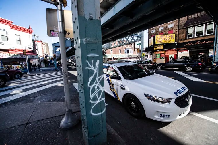 A police car patrols Kensington Ave, near McPherson Square. At least three women have been sexually assaulted at gunpoint in the area by a man targeting vulnerable women, police said.