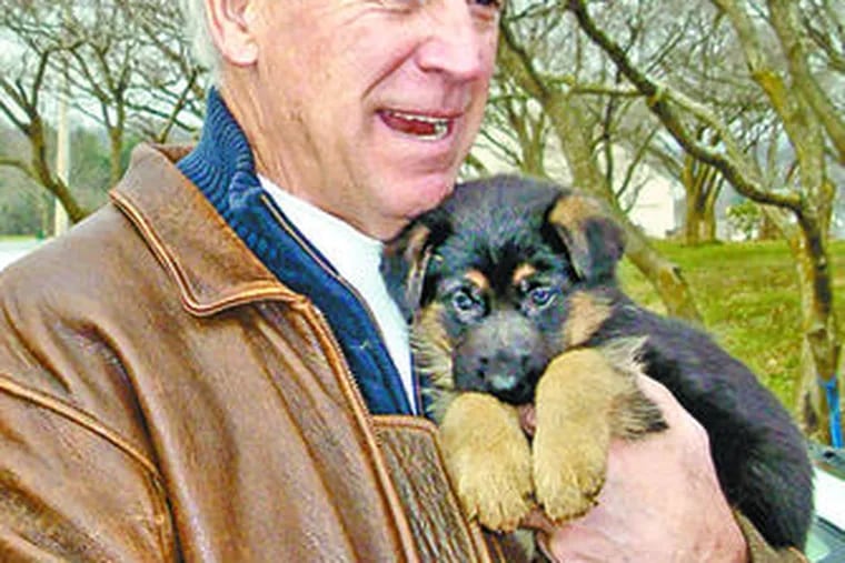 Vice President-elect Joseph R. Biden Jr. with the German shepherd puppy he bought at a kennel in Chester County. Some criticized Biden for not adopting a pup. B3.