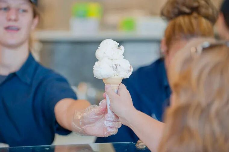 Student serves cone at Berkey Creamery, Penn State. (Penn State photo)