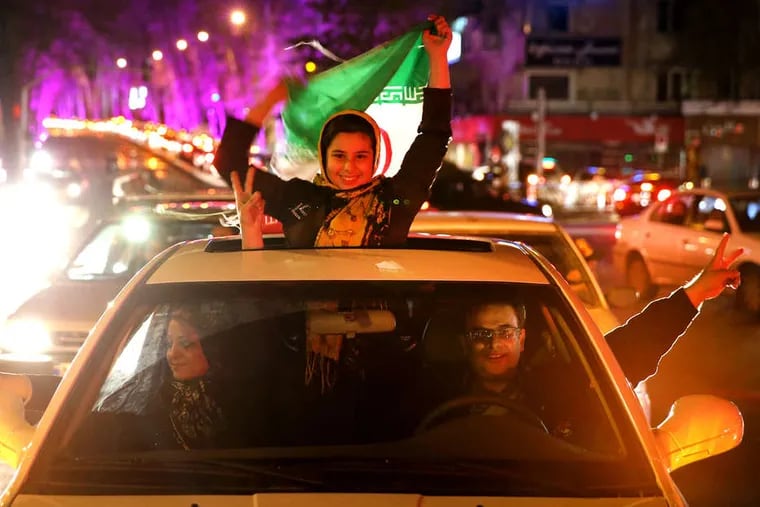 Iranians celebrate on a street in northern Tehran upon hearing that their nation reached a nuclear outline with world powers at talks in Lausanne, Switzerland.