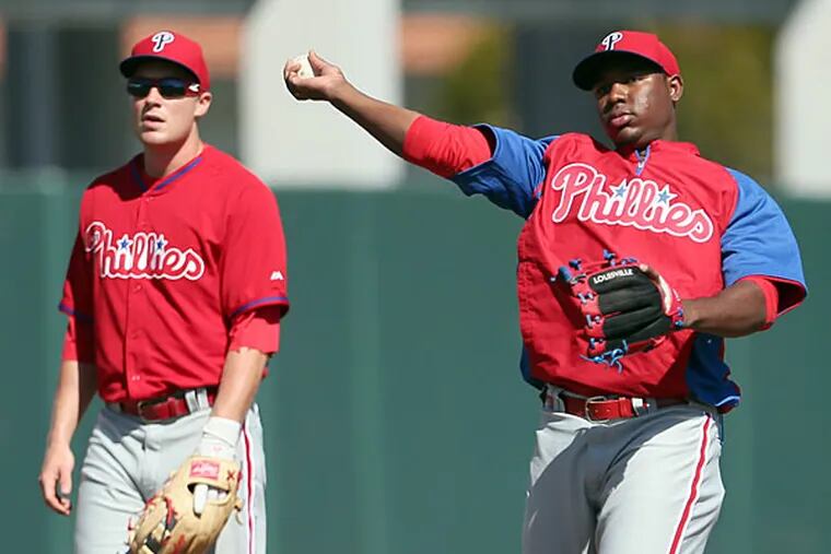 Phillies third baseman Cody Asche (left) and prospect Maikel Franco (right). (Yong Kim/Staff file photo)