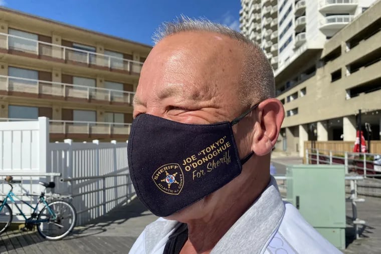 With a "Tokyo Joe" mask, Joe O'Donoghue campaigns on the Atlantic City Boardwalk on Sunday. The nickname dates to his youth, and to a grandfather who was the first Japanese American given citizenship in Atlantic County. O'Donoghue wants to be sheriff of Atlantic County.