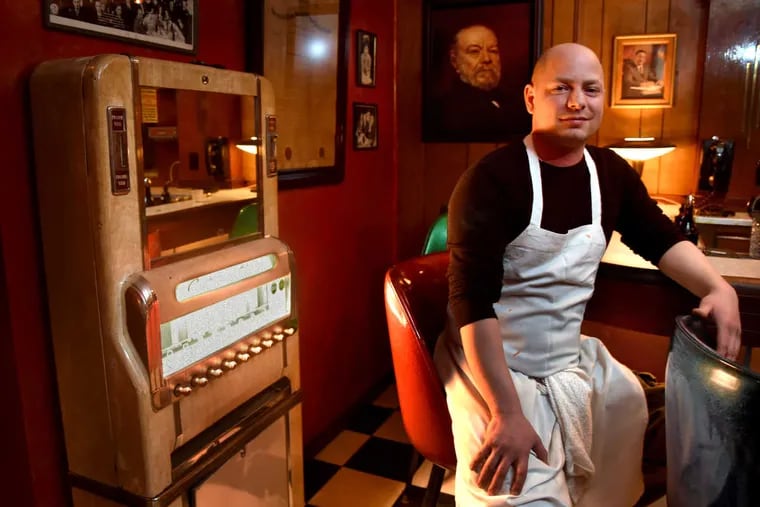 Joey Baldino at the bar of the Palizzi Social Club in South Philadelphia.  He is taking over his family's old-time, private social club, setting it up with a homespun menu. At left is a non-functioning 35-cent-a-pack cigarette machine. At right, a portrait of Frank Rizzo.