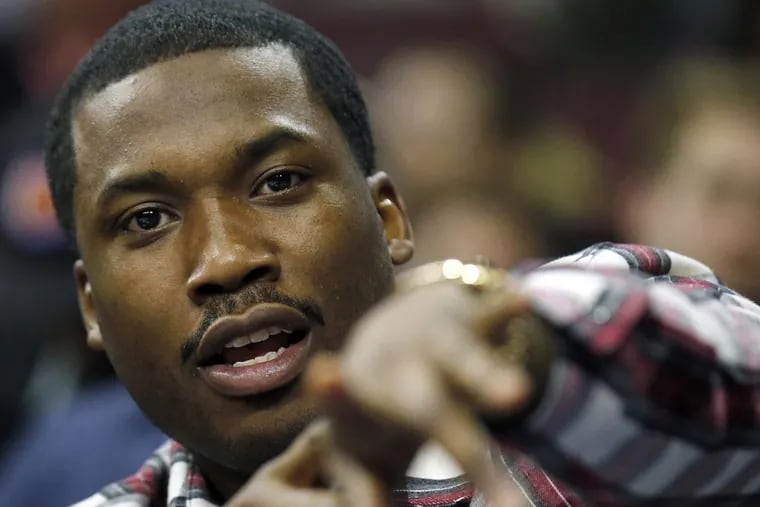 Hip-hop artist Meek Mill attends as the Philadelphia 76ers play host to the Sacramento Kings on February 10, 2016, at the Wells Fargo Center in Philadelphia. Despite serving a 2- to 4-year prison term for violating the terms of his 10-year-old probation, Mill’s team will still give away turkeys.
