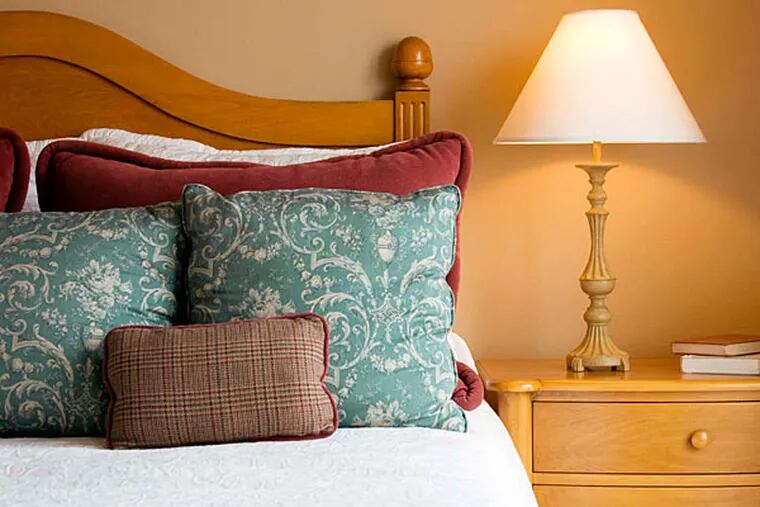 Fresh pillows and a nightstand with a light are among the amenities that put guests at ease. (iStock image)
