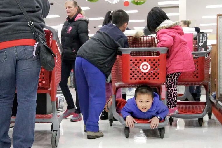Ivan Liu, 9, of Deptford, rides a shopping cart as his family shops at the Deptford Target.
