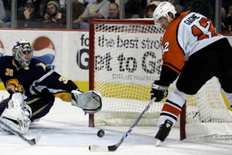 Sabres goaltender Ryan Miller reaches out to stop a shot by Simon Gagne in the second period in Buffalo.