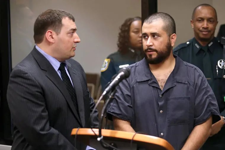 George Zimmerman, acquitted in the high-profile killing of unarmed black teenager Trayvon Martin, talks to defense counsel Daniel Megaro, left,  Tuesday, Nov. 19,  2013, in Sanford, Fla., during Zimmerman's hearing on charges including aggravated assault stemming from a fight with his girlfriend.  (AP Photo/Orlando Sentinel, Joe Burbank, Pool)