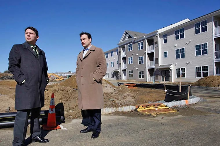 Richard DiFolco, (left) mayor of Mount Holly, and George R. Saponaro, township counsel, tour a newly built apartment complex near Mount Holly Gardens. (MICHAEL S. WIRTZ/Staff Photographer)