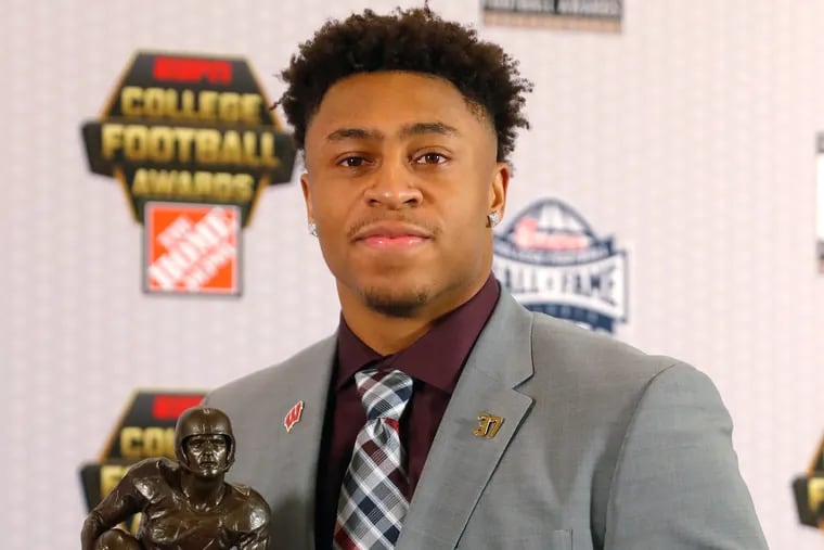 Wisconsin's Jonathan Taylor poses with the trophy after winning the Doak Walker Award as top running back in college football, Thursday, Dec. 6, 2018, in Atlanta. (AP Photo/John Bazemore)