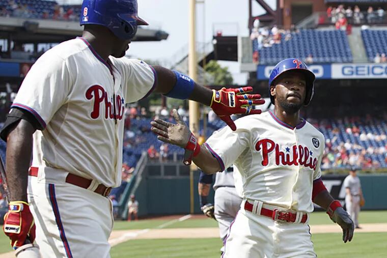 Jimmy Rollins, right, celebrates his run with Ryan Howard, left, on a single by Chase Utley during the fifth inning against the Seattle Mariners on Wednesday, Aug. 20, 2014, in Philadelphia. (Chris Szagola/AP)