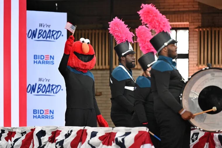 Philly Elmo and his drum line make a brief appearance in the gym at Girard College on Wednesday before President Joe Biden and Vice President Kamala Harris held a campaign rally to announce an initiative aimed at gaining support from Black voters.