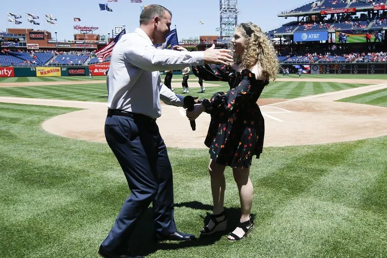 Former Phillies slugger Jim Thome gets ready to hug daughter Lila after she sang the national anthem before a June game at Citizens Bank Park.