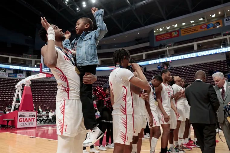 Tymir Leigh, 5, high fives his big brother, Imhotep's Justin Edwards, after the Panthers won the PIAA 5A boys' basketball final.